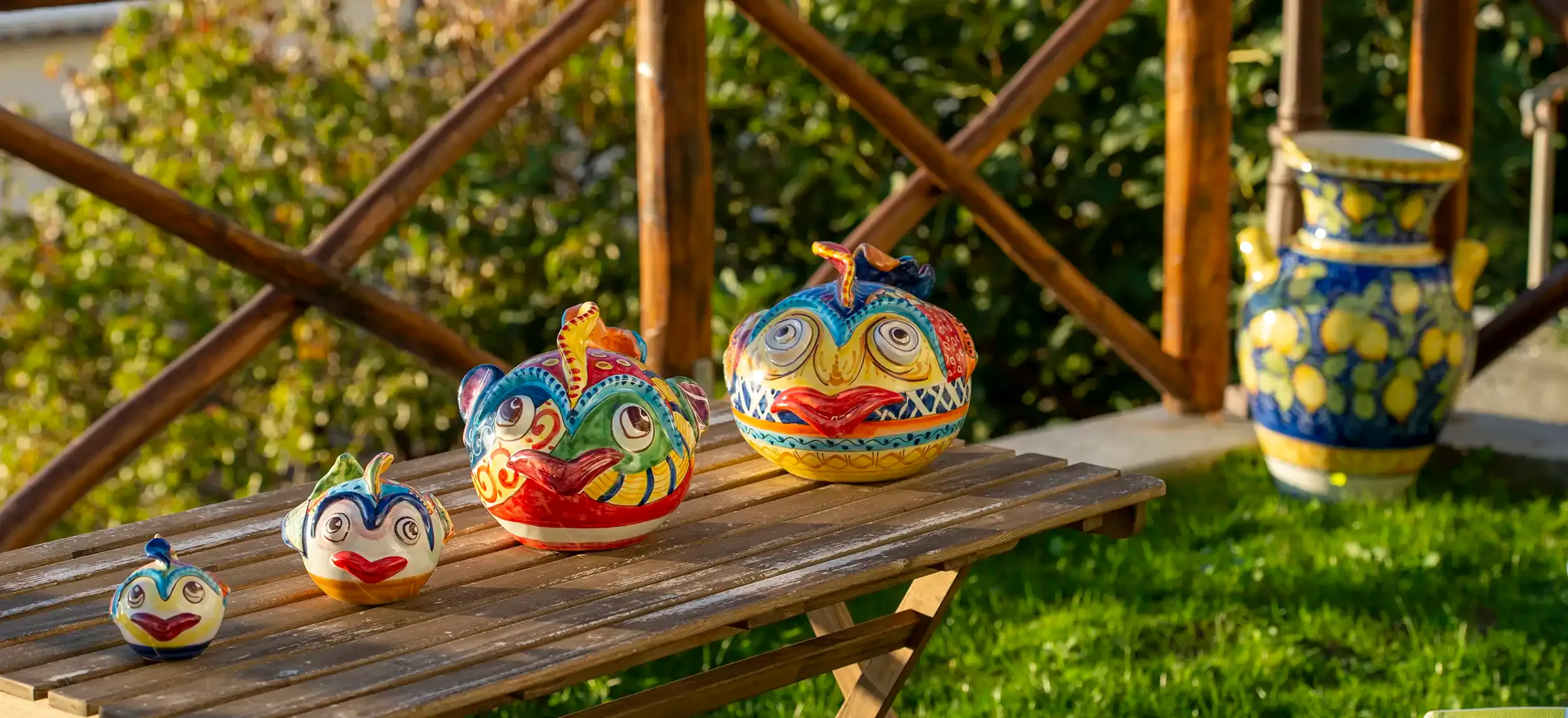 Handcrafted ceramics displayed in the garden at Ceramiche Da Mario